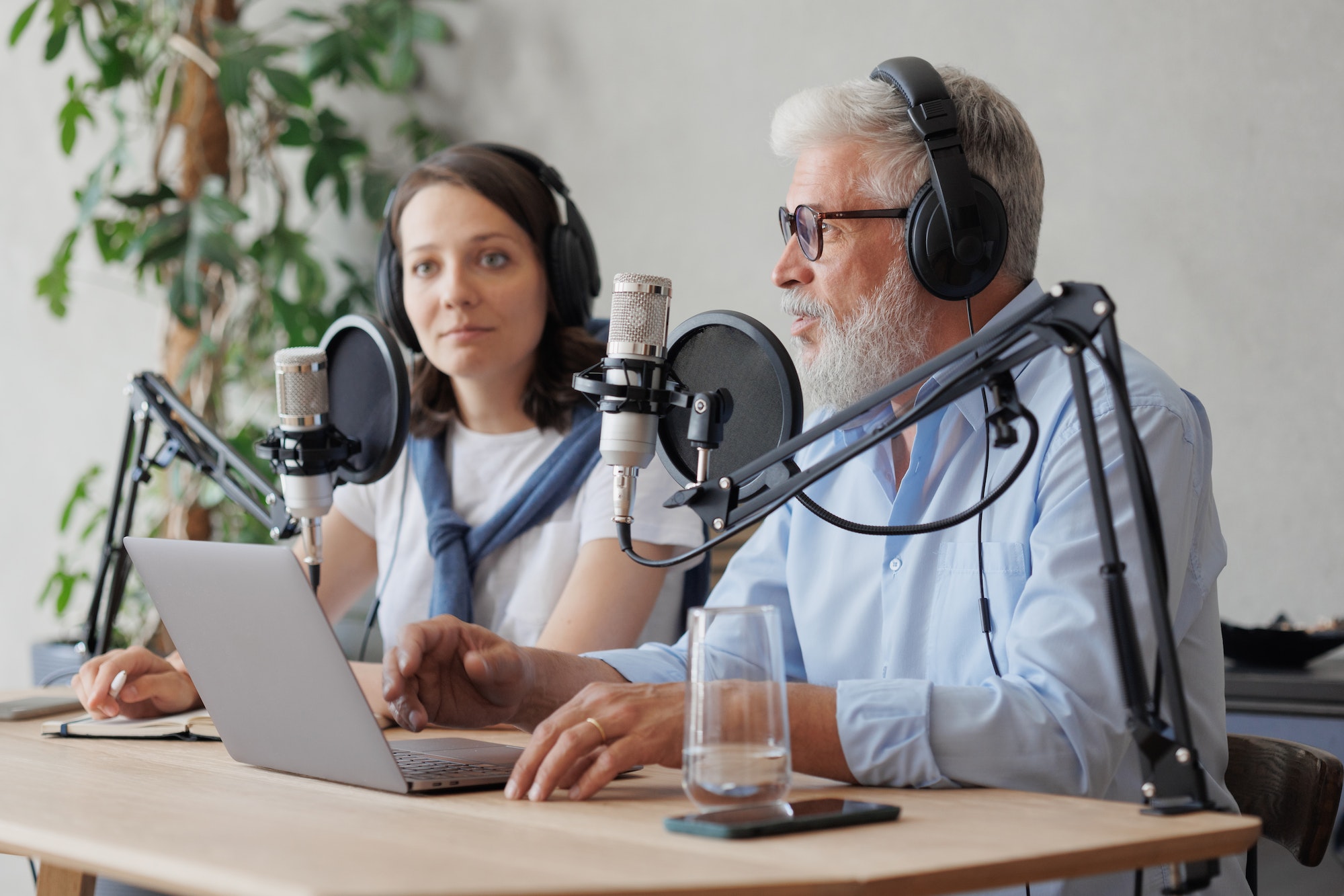 older-man-and-female-presenter-in-a-recording-studio-create-a-podcast-senior-woman-radio-presenter.jpg